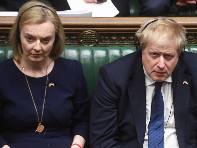 A handout photograph released by the UK Parliament shows (From L) Britain's Foreign Secretary Liz Truss, Britain's Prime Minister Boris Johnson and Britain's Home Secretary Priti Patel listening to Ukraine's President Volodymyr Zelensky speaking to them by live video-link in the House of Commons, in London, on March 8, 2022. - Ukraine's President Volodymyr Zelensky, invoking the wartime defiance of British prime minister Winston Churchill, vowed on March 8, 2022 to "fight to the end" in a historic virtual speech to UK lawmakers. "We will not give up and we will not lose," he said, recounting a day-by-day account of Russia's invasion that dwelt on the costs in lives of civilians including Ukrainian children. (Photo by JESSICA TAYLOR / UK PARLIAMENT / AFP) / RESTRICTED TO EDITORIAL USE - NO USE FOR ENTERTAINMENT, SATIRICAL, ADVERTISING PURPOSES - MANDATORY CREDIT " AFP PHOTO / Jessica Taylor /UK Parliament"