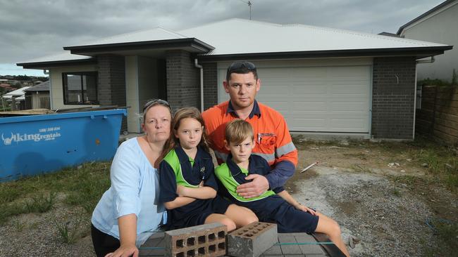 Martin Sorrell, wife Kristi Sorrell and children, Sasha 8 and Marcus 7, in front of their partially built home at Ormeau Hills. Kristi and her family were building with Future Urban Residential, which is now unlicensed and their home is unfinished. Picture: Glenn Hampson