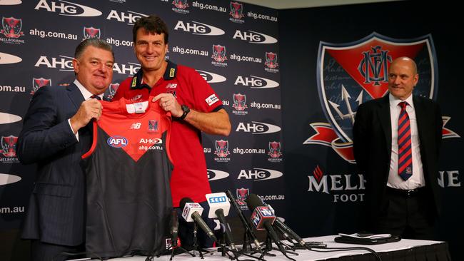 Then-Melbourne coach Paul Roos (middle) and CEO Peter Jackson (right) announce a new guernsey sponsorship deal with AHG’s Bronte Howson in 2013. Picture: Colleen Petch