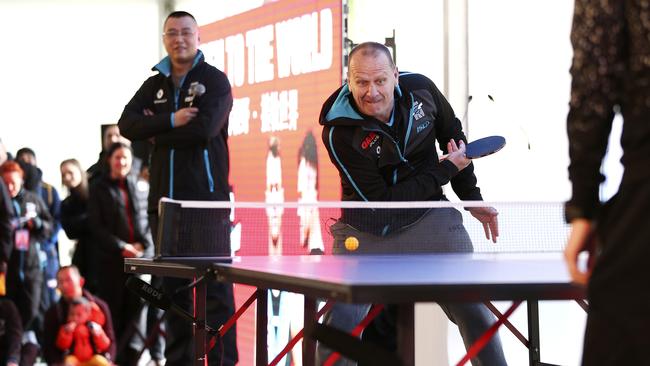 Ken Hinkley, playing table-tennis on Port’s China trip in 2016, bonded with players over the court on the club’s pre-season camp. Picture: Sarah Reed