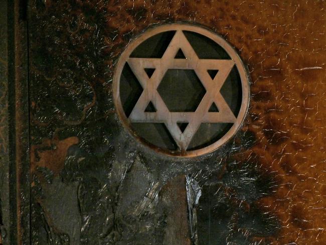 A picture taken in Rouen on May 17, 2024 shows a Star of David on a partially burnt wall of a synagogue after a man tried to set it on fire early in the morning. French police on May 17, 2024 shot dead an Algerian man armed with a knife and an iron bar who tried to set fire to a synagogue in the northern city of Rouen, adding to concerns over anti-Semitic violence in the country. Emergency services were alerted after a fire was detected at the synagogue, with the man spotted on its roof brandishing an iron bar and a kitchen knife, the prosecutor handling the case said. (Photo by LOU BENOIST / AFP)