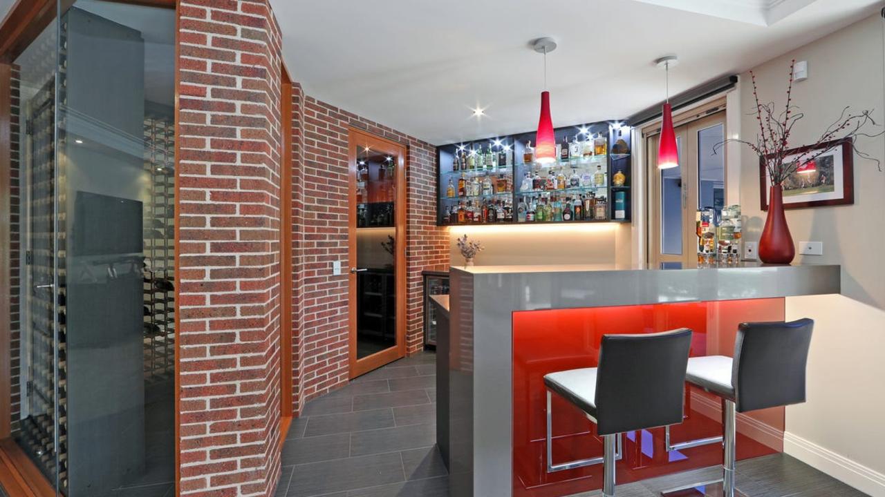 A boldly coloured home bar added to the appeal.