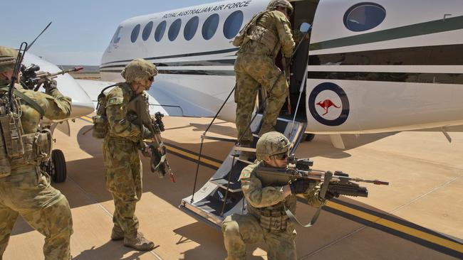 Australian Army soldiers from the Ready Combat Team board an aircraft suspected of carrying drugs, explosives and weapons as part of exercise Northern Shield 2015 in RAAF Learmonth. Picture: Defence