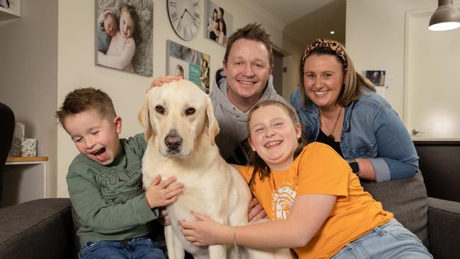 Archer, the blond labrador has won the cutest dog in Victoria Tim and Loren Parker with kids Keely, 10 and Elliott, 5 at their home in Cranbourne North. Picture: Jason Edwards