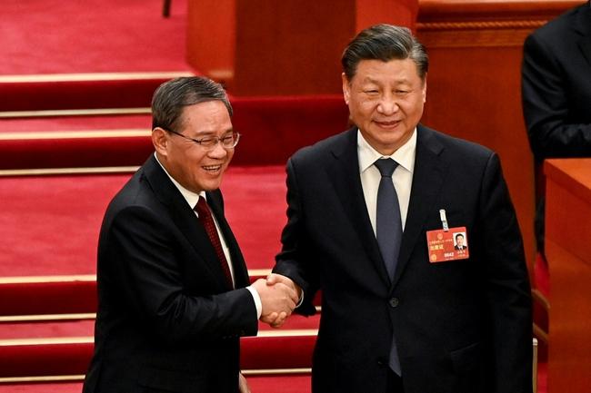 Li Qiang (L) received nearly all votes from the more than 2,900 delegates