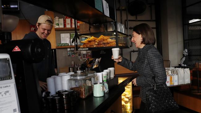 NSW Premier Gladys Berejiklian gets her morning coffee from her local cafe in Sydney’s Northbride on Friday as restrictions eased slightly. Picture: Nikki Short