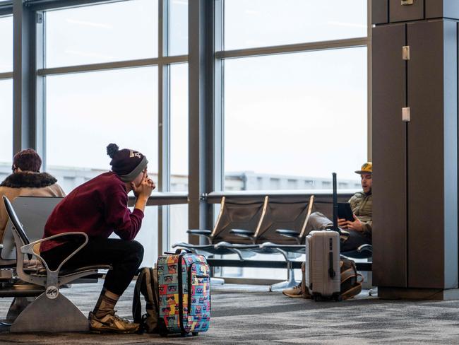 AUSTIN, TEXAS - JANUARY 15: A traveler sits waiting for their flight to depart at the Austin Bergstrom International Airport on January 15, 2024 in Austin, Texas. Airlines across the country continue experiencing mass cancellations and delays as intense storms continue sweeping across the eastern half of the United States.   Brandon Bell/Getty Images/AFP (Photo by Brandon Bell / GETTY IMAGES NORTH AMERICA / Getty Images via AFP)