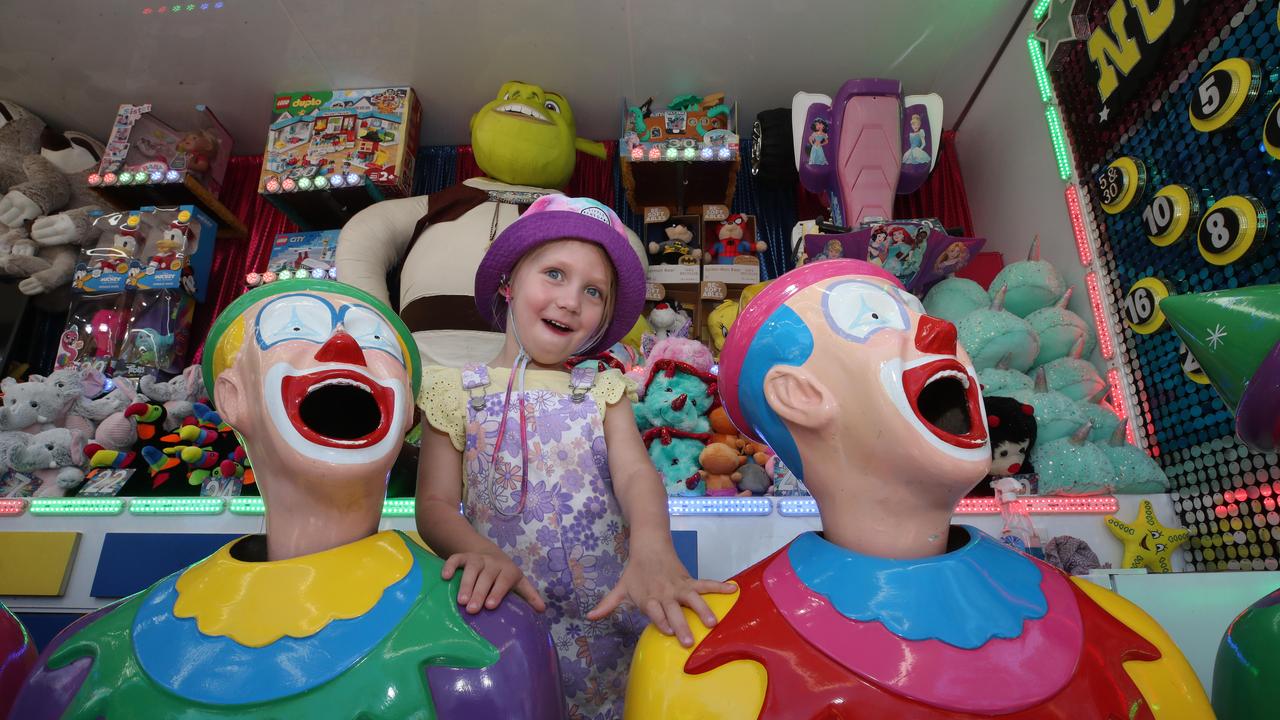 Huge crowds for the first day of the Gold Coast Show. Laughing with the clowns is Lennox Bridge, 4. Picture: Glenn Hampson