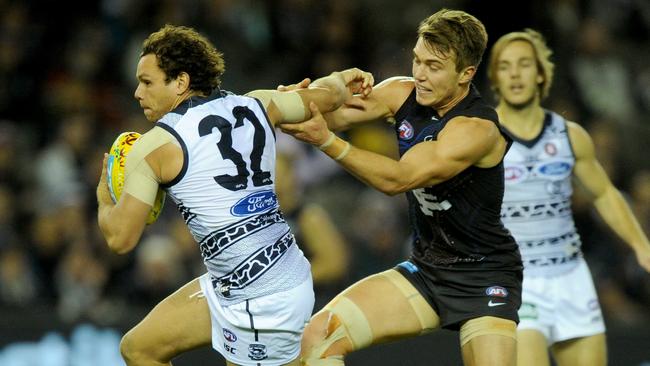 Patrick Cripps trying to stop Steven Motlop in full flight. Picture: AAP