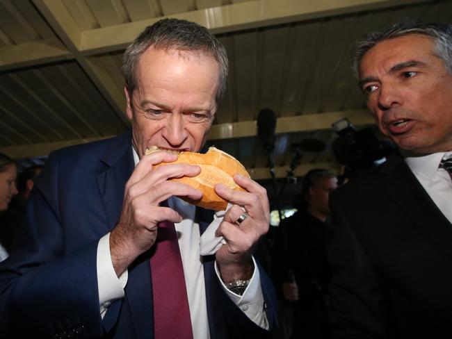 Here’s Shorten horrible attempt at eating a sausage. Very un-Australian. Picture: Kym Smith