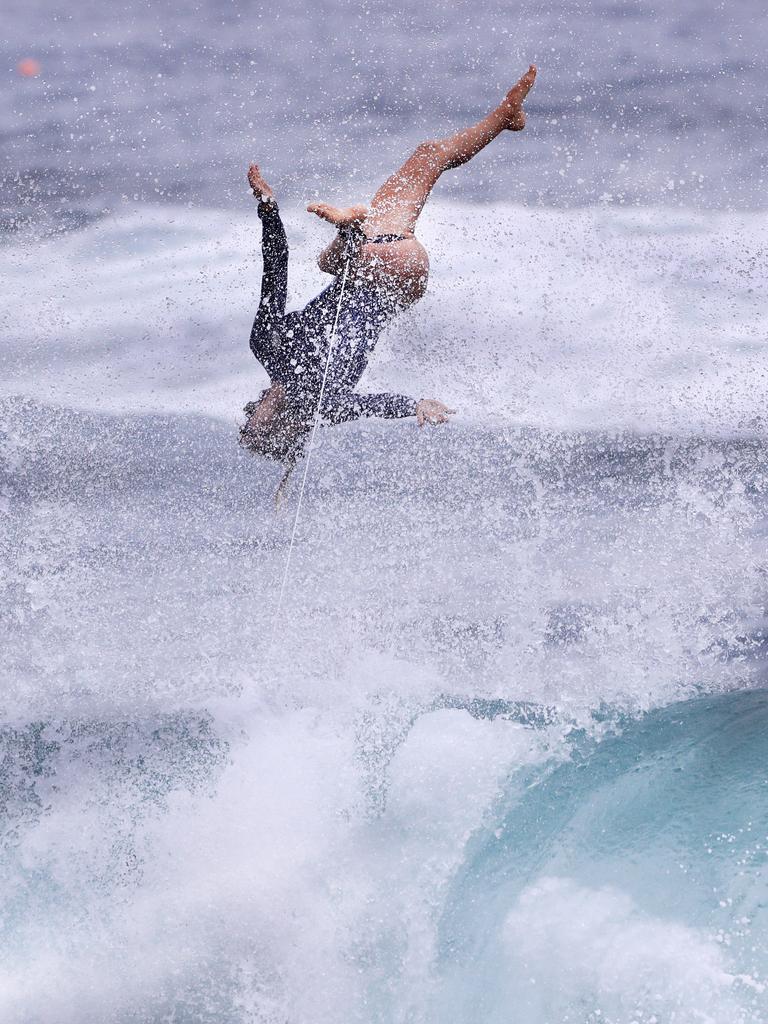 Australian junior female surfer Molly Picklum takes off on a wave at Burleigh point as wet weather descended over the Gold Coast. Photo: Scott Powick NEWSCORP