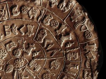 The Phaistos disc front. Disc of fired clay covered on both sides with a spiral of stamped symbols, c.15 cm, c.1700-1600 BC. Minoan art. Heraklion Archaeological Museum Crete. (Photo by: Leemage/UIG via Getty Images)