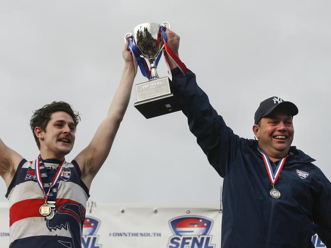 Highett captain Tom Brown and coach Sam Hecker lift the 2018 Division 2 premiership cup.