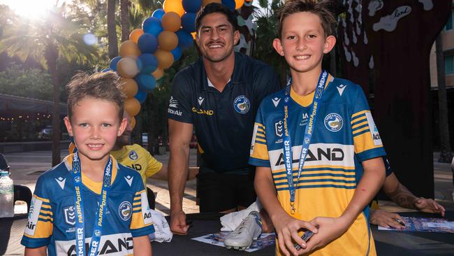 Parramatta Eels player Dylan Brown signing the boots he gave to Ryan and Nate Burke at the end of last years match against the Cowboys. Picture: Pema Tamang Pakhrin