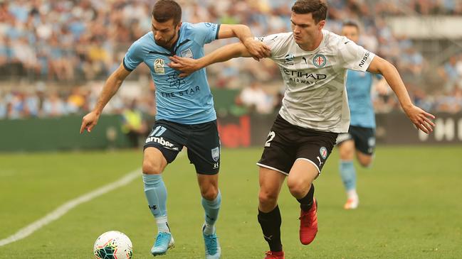 Kosta Barbarouses takes on Curtis Good of Melbourne City.