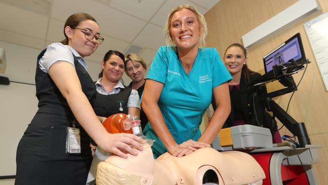 Nerang MP Meaghan Scanlon at Gold Coast University Hospital announcing 155 nursing and midwifery graduates for Gold Coast hospitals. Midwife Alexandria Slater (left) and nursing graduate Brooke Rudman (green) show their resuscitation techniques in front of fellow graduates Cherelle Cowl, Nova Knoll, and MP Meaghan Scanlon. Picture Glenn Hampson
