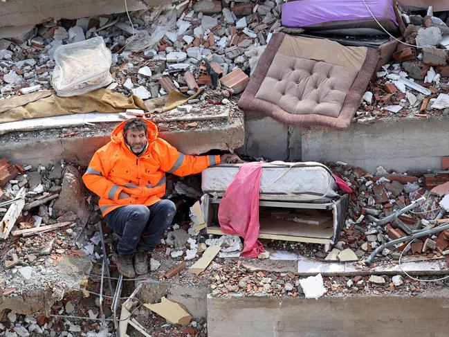 Father Mesut Hancer holds the hand of his 15-year-old daughter Irmak, who died in the earthquake in Turkey, close to the quake's epicentre, the day after a 7.8-magnitude earthquake struck the country in February. Picture: Adem Altan/AFP