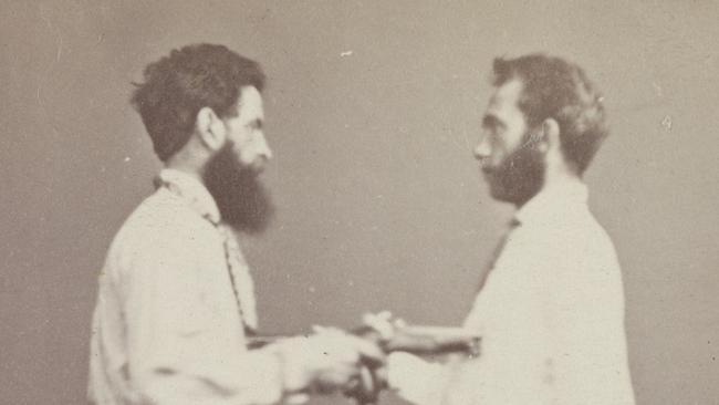 One of two studio portrait photographs, carte de visite size, of Charles Marks (right) and Edward Feeney. One shows them shaking hands and one has them pointing pistols at each other's chests. They apparently made a suicide pact and commissioned photographs of themselves with the guns beforehand. Feeney killed Marks but remained unscathed himself. He was later hanged for murder. Please credit State Library Victoria.