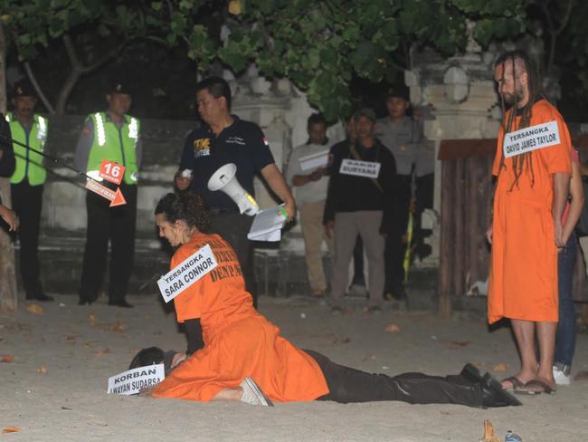 Sara Connor appears to sit on top of the officer during the re-enactment at Kuta Beach as her boyfriend David Taylor looks on. Picture: Zul Edoardo.