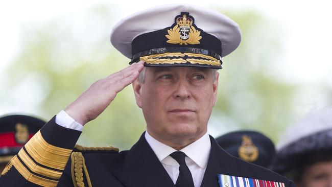 Prince Andrew, Duke of York, salutes military personnel during an Armed Forces day parade in Guildford.