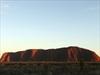 The sun rises over Uluru