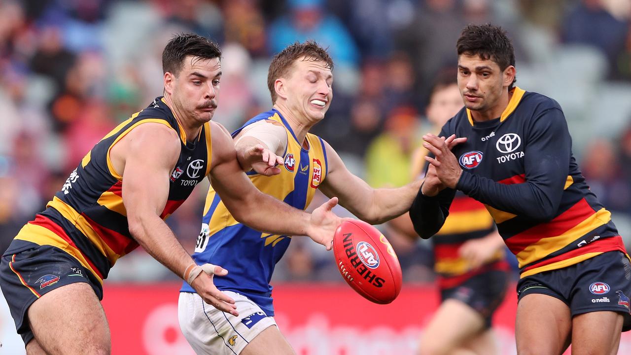 Darcy Fogarty of the Crows, Alex Witherden of the Eagles and Shane McAdam of the Crows. Photo by Sarah Reed/AFL Photos via Getty Images