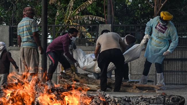 A coronavirus victim is laid on a funeral pyre at a crematorium in New Delhi this week. Picture: AFP