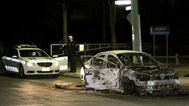 This car was set alight in Rees St, Mays Hill not long after the shooting. Picture: Steve Tyson