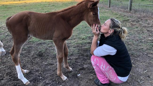 Laura Cheshire with a foal born in care out of a raced thoroughbred mare. Picture: Supplied