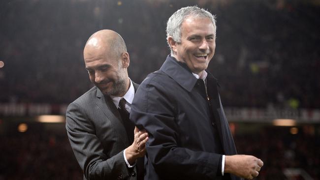Manchester United's Portuguese manager Jose Mourinho (R) and Manchester City's Spanish manager Pep Guardiola.