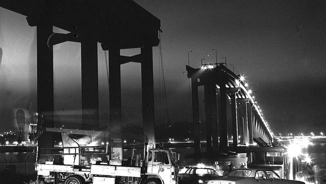 Don Stephens’ amazing image of the Tasman Bridge disaster showing headlights of the cars teetering on the brink.