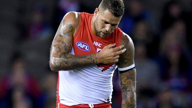 Lance Franklin feels his shoulder after a marking contest.