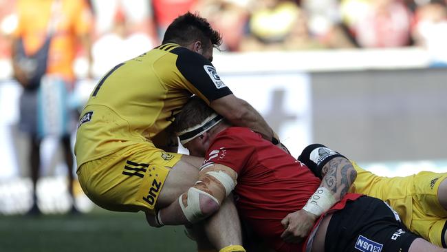 Hurricanes winger Wes Goosen fails to stop a try by Lions prop Jacques van Rooyen.