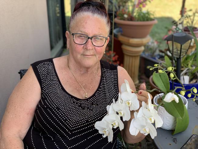 Glenella mum Robyn 'Robbi' Mapley honoured former workmate Brendan Moreland in a heartfelt tribute following his shock death. She tenderly cradles an orchid he gifted her about 12 months ago before she went into hospital.