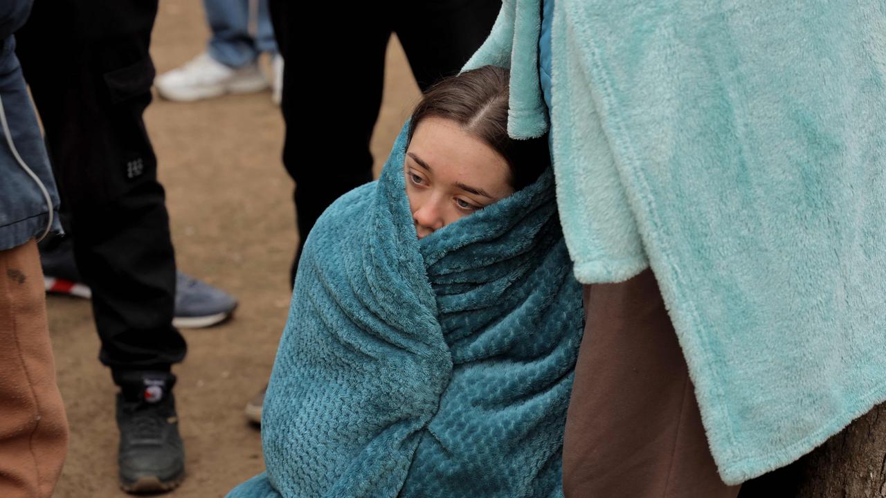 A local resident, wrapped in a blanket to protect from the cold, sits in front of a heavily damaged multi-story apartment building, following a Russian drone attack, in Odessa. Picture: AFP