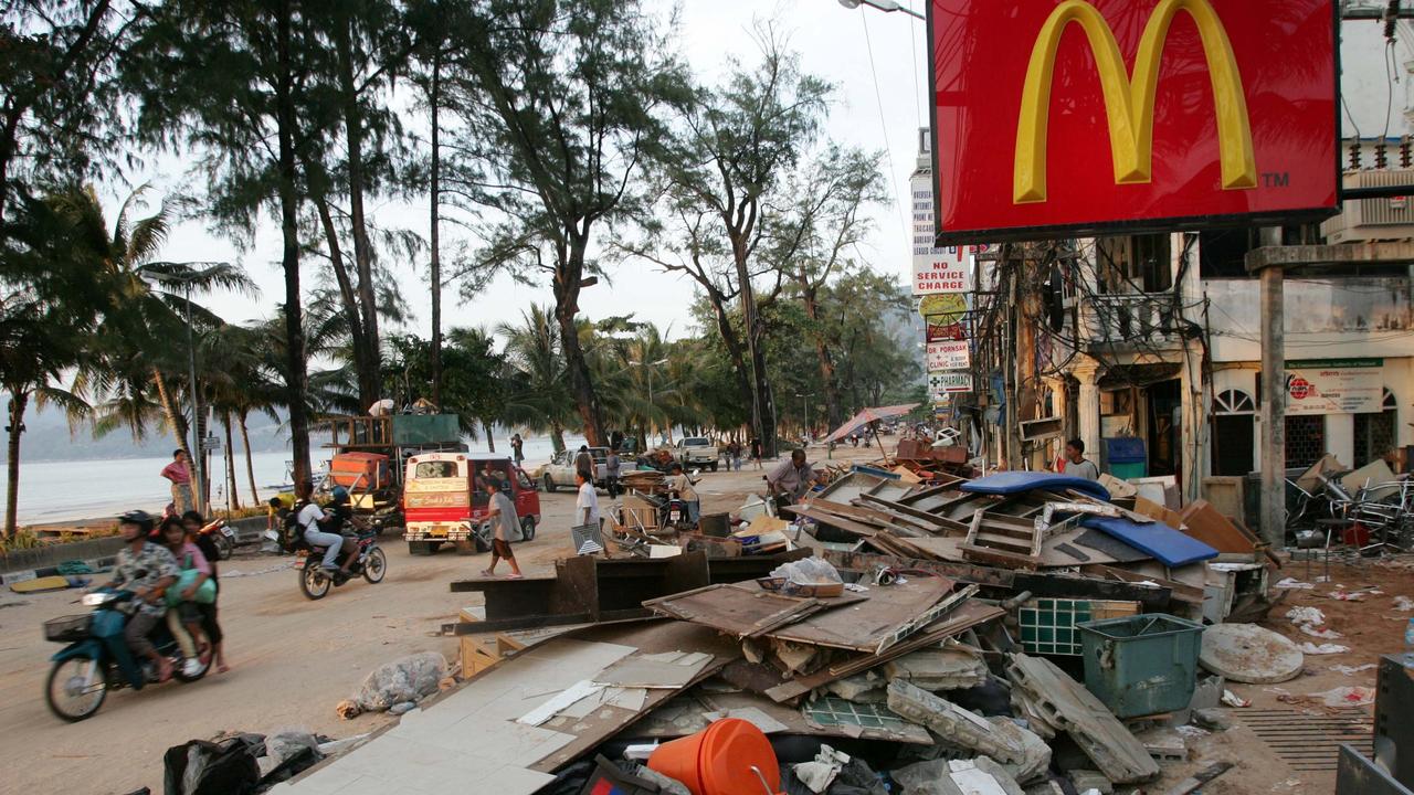 Locals survey the damage at Patong Beach in Phuket after the tsunami. Picture: AFP