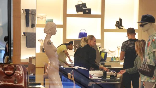 Louis Vuitton staff cleaning up after a ram raid on their CBD store in Brisbane. Picture: Liam Kidston