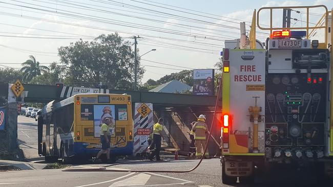 Crews work to free Translink bus at Graceville.