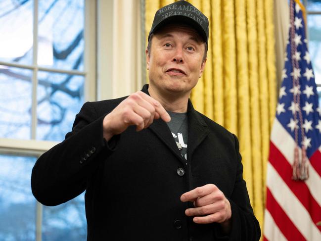 Elon Musk speaks in the Oval Office of the White House in Washington, DC, on February 11, 2025. Tech billionaire Elon Musk, who has been tapped by President Donald Trump to lead federal cost-cutting efforts, said the United States would go "bankrupt" without budget cuts. Musk leads the efforts under the newly created Department of Government Efficiency (DOGE), and was speaking at the White House with Trump, who has in recent weeks unleashed a flurry of orders aimed at slashing federal spending. (Photo by Jim WATSON / AFP)