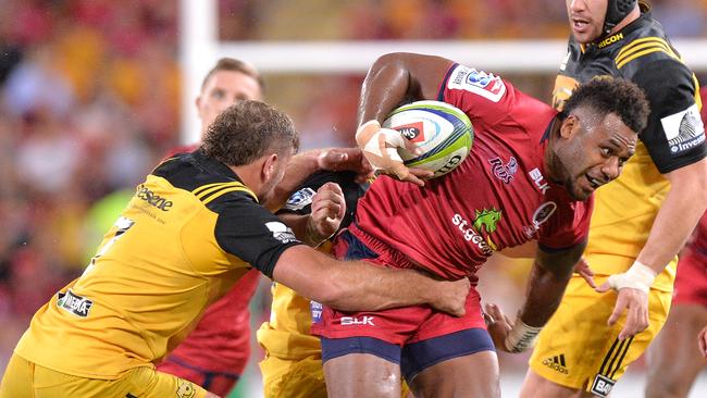 Reds player Samu Kerevi attempts to break away from the defence.