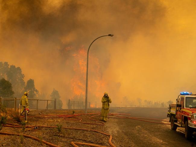 A supplied image obtained on Wednesday, February 3, 2021, of Fire fighters in Western Australia battling a blaze at Wooroloo, near Perth, Tuesday, February 02, 2021. More than 70 homes have been destroyed by a bushfire that's been burning out of control in Perth's northeastern suburbs since Monday. (AAP Image/Supplied by DFES, Evan Collis) NO ARCHIVING, EDITORIAL USE ONLY