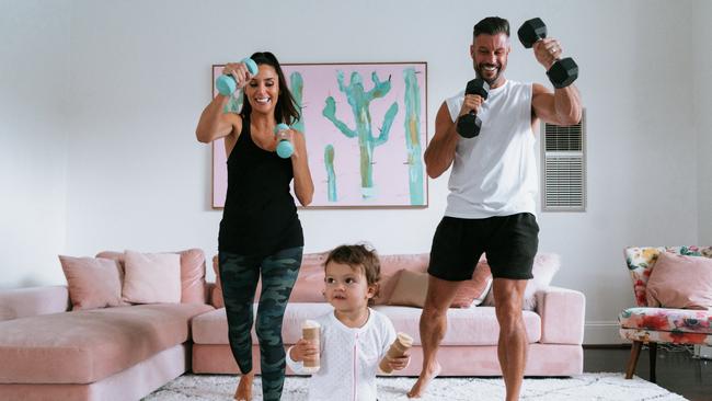 Sam Wood, his wife Snezana and his daughter Willow working out at home. Picture: Supplied