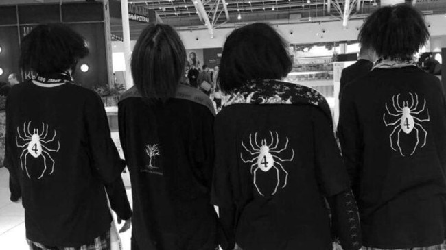 PMC Ryodan teenagers, with their distinctive black tops and spider logos