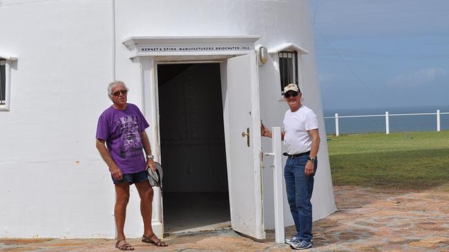 Stuart Buchanan and Bustard Head lighthouse volunteer Dudley Fulton at the entrance to the lighthouse. Above the door is the name of the company that manufactured the historic lighthouse, Hennett and Spink, Bridgwater 1866.