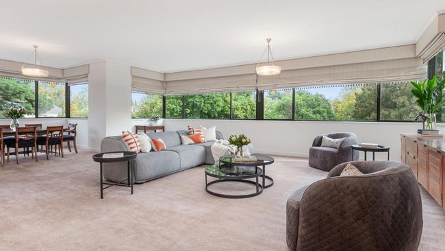 The light-filled apartment has a large reception area, living and dining room with views over the neighbourhood and gardens.