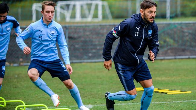 Milos Ninkovic, right, at Sydney FC training in the rain yesterday. Picture: AAP