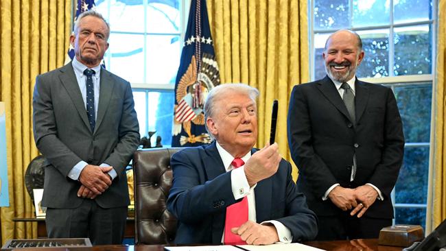 US President Donald Trump holds a sharpie after signing an Executive Order, alongside US Secretary of Health and Human Services Robert F. Kennedy Jr. (L) and US Secretary of Commerce nominee Howard Lutnick (R), at the Oval Office of the White House in Washington, DC on February 25, 2025. Trump signed an executive order on price transparency requirements on the health care industry to reinstate and strengthen them. He also signed an order on the supply of copper and foreign copper in the American market, the order charges Lutnick with looking at process to potentially impose tariffs or trade barriers. (Photo by Jim WATSON / AFP)