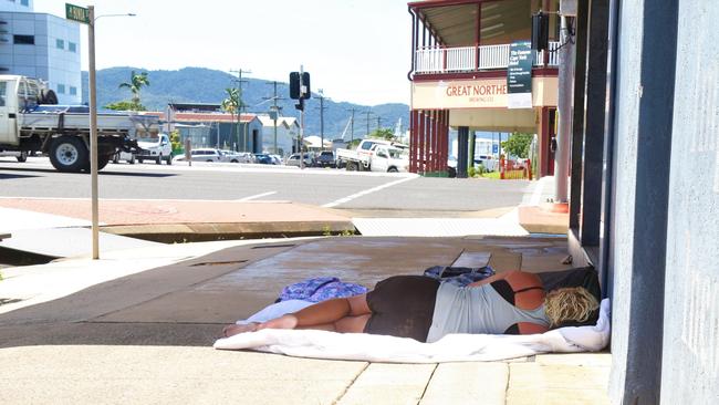 A woman asleep on the footpath outside the Anglicare office on Bunda St, Cairns. Picture: Peter Carruthers