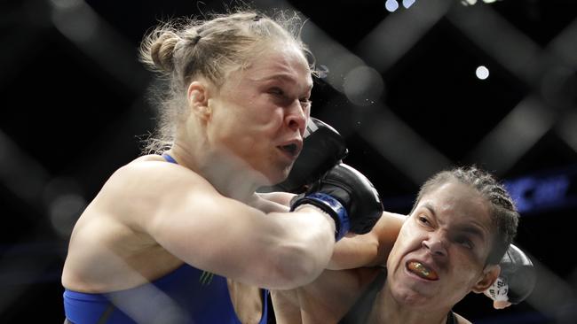 Ronda Rousey gets belted in the face.