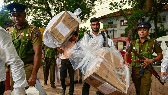 Election officials and security personnel transport sealed ballot boxes to a counting centre at the end of voting in Sri Lanka's legislative elections in Colombo on Thursday. Picture: AFP